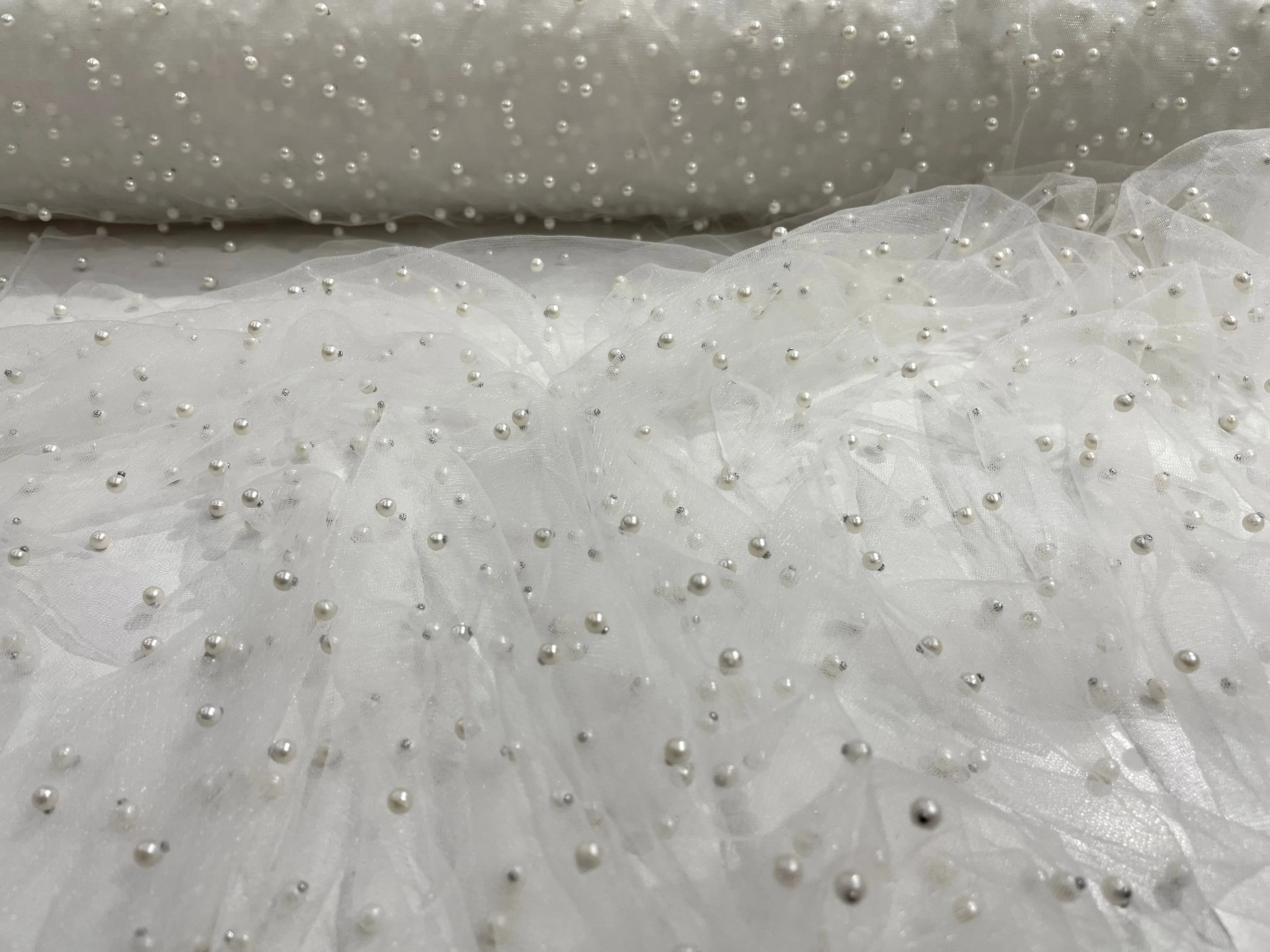 White Scattered Pearls Studded Mesh, 2-Way Stretch, sold by the yard.